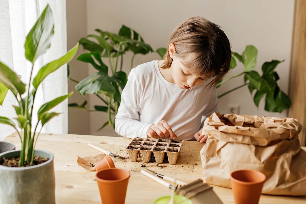A girl planting seeds inside.