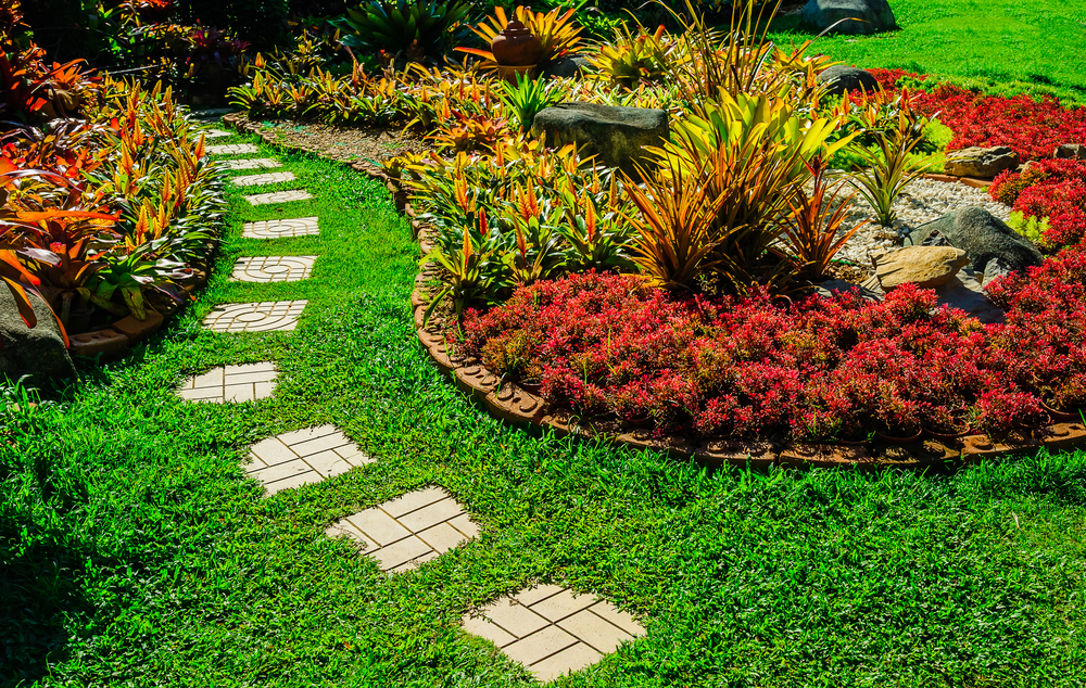 A beautiful lawn and garden with a pathway.